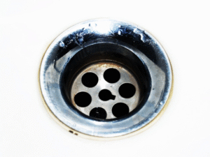 A clean, shiny sink drain shows Rhino Rooters expert pipe cleaning services for homes in The Wasatch Front.